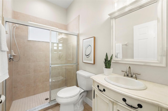 bathroom with an enclosed shower, vanity, toilet, and tile patterned flooring