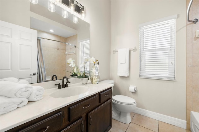 bathroom featuring toilet, vanity, tile patterned floors, and plenty of natural light