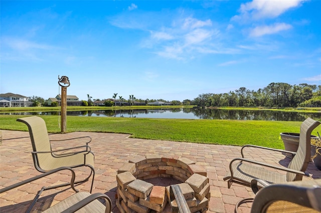 view of patio with a water view and an outdoor fire pit