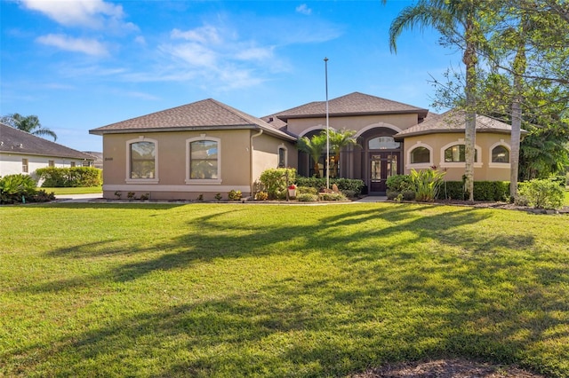 mediterranean / spanish home featuring a front yard