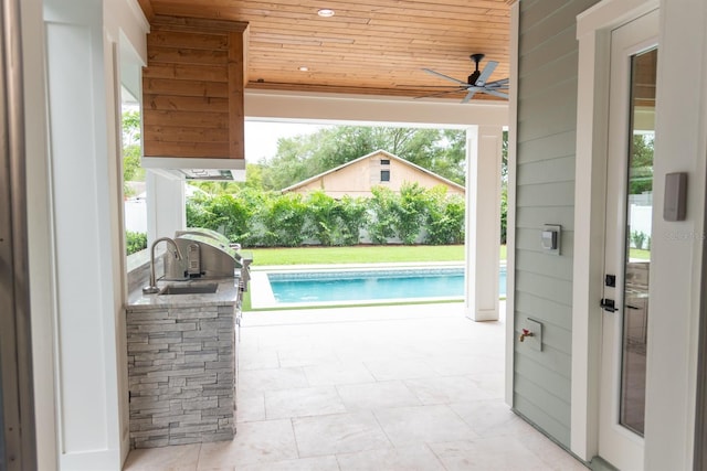 view of swimming pool with area for grilling, ceiling fan, a patio area, and sink