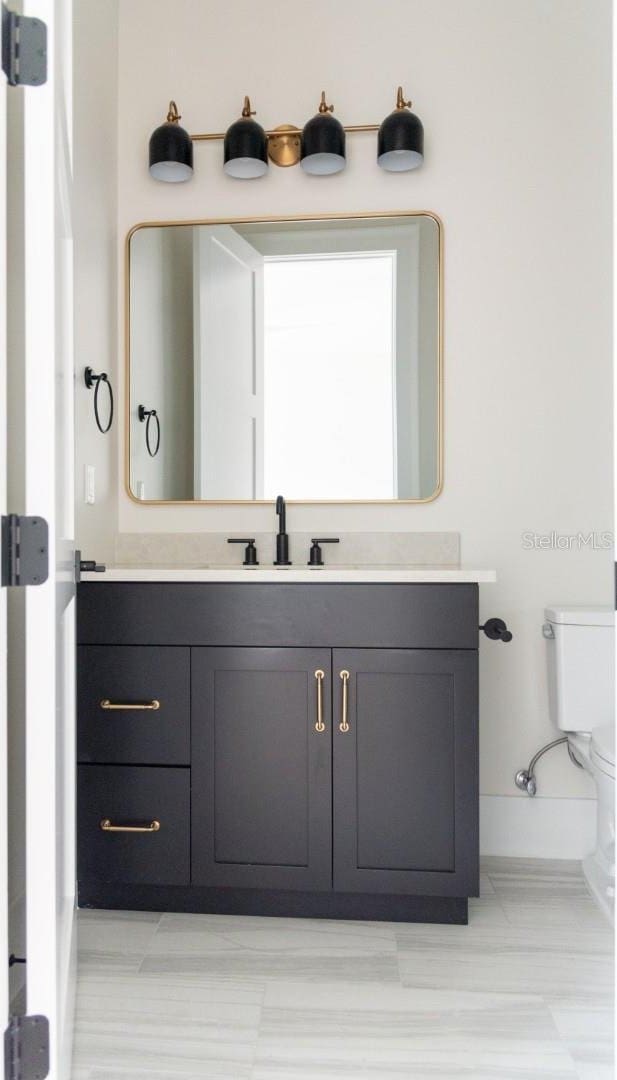 bathroom with vanity and toilet