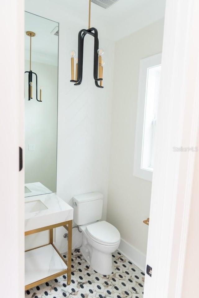 bathroom with tile patterned flooring and toilet