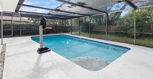 view of pool featuring glass enclosure and a patio area