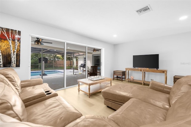 living room featuring ceiling fan and light hardwood / wood-style floors