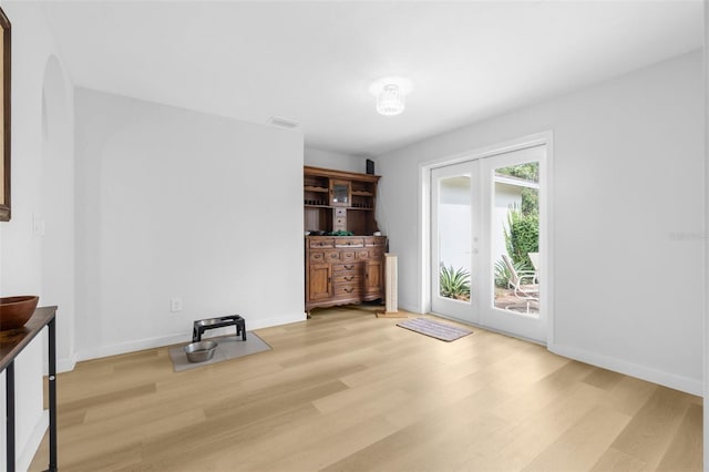 interior space with light hardwood / wood-style floors and french doors