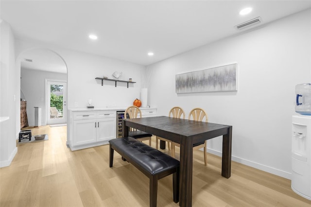 dining room with light wood-type flooring and beverage cooler