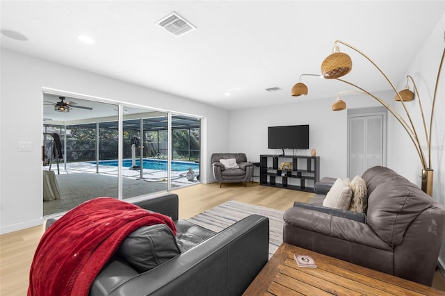 living room with hardwood / wood-style floors and ceiling fan