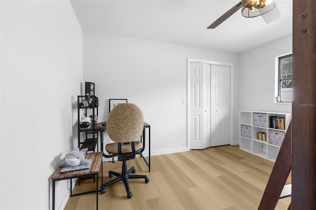 office with ceiling fan and light hardwood / wood-style floors