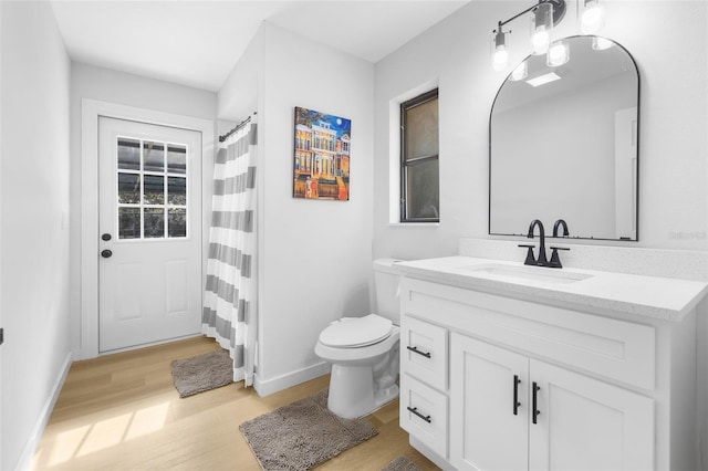 bathroom with hardwood / wood-style flooring, vanity, and toilet