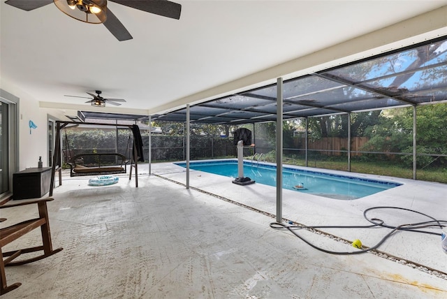 view of pool with a patio and glass enclosure