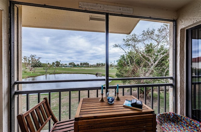 balcony featuring a water view