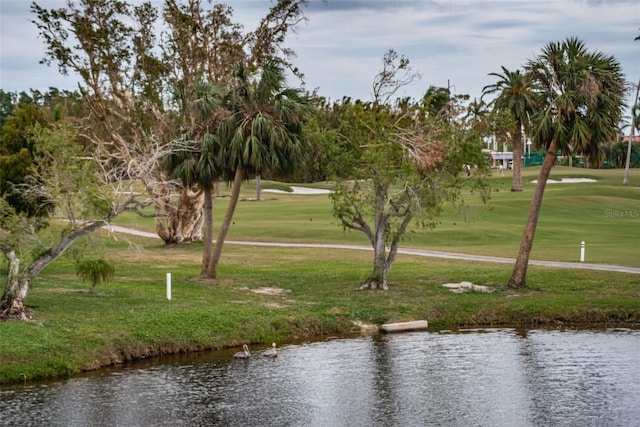 surrounding community featuring a water view and a yard