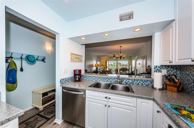 kitchen with white cabinetry, dishwasher, hanging light fixtures, an inviting chandelier, and light hardwood / wood-style flooring