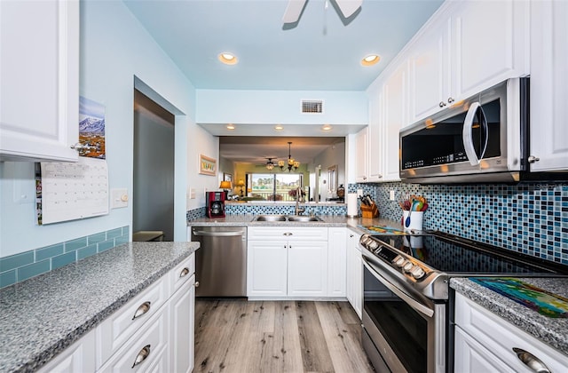 kitchen with sink, white cabinets, and stainless steel appliances