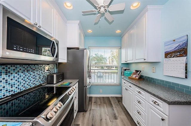 kitchen with ceiling fan, stainless steel appliances, tasteful backsplash, light hardwood / wood-style flooring, and white cabinets