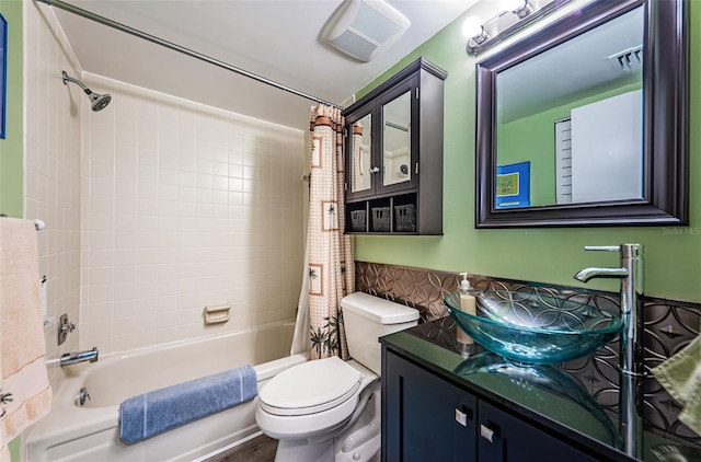 full bathroom featuring shower / tub combo, vanity, and toilet