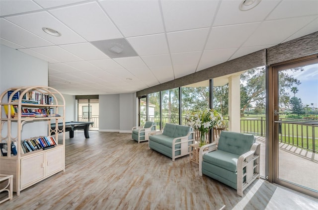 interior space with a paneled ceiling and pool table