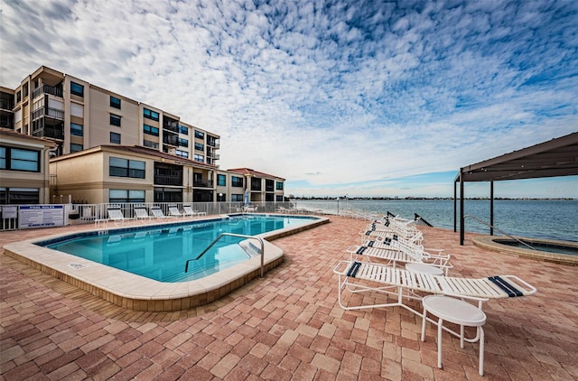 view of pool with a water view