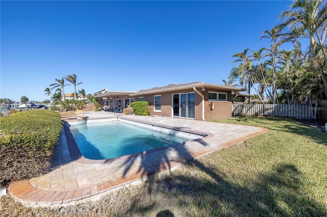 view of swimming pool with a yard and a patio