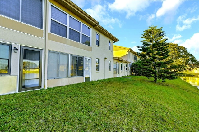 back of house featuring a lawn