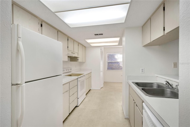 kitchen with sink, white appliances, and cream cabinetry