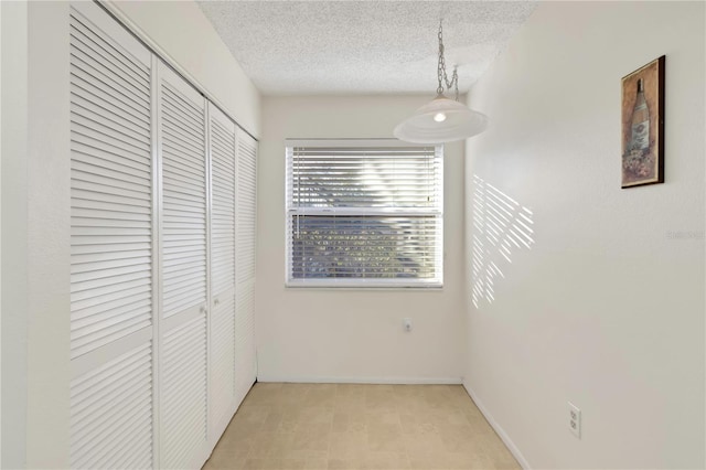 unfurnished bedroom featuring a closet and a textured ceiling