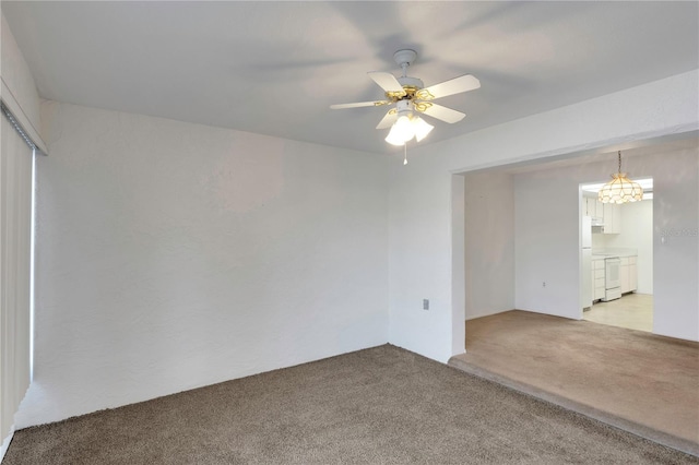 spare room featuring light carpet and ceiling fan