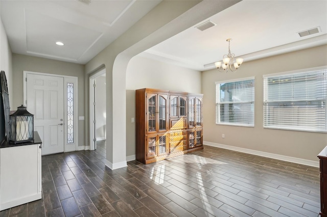 entrance foyer with a chandelier and dark wood-type flooring