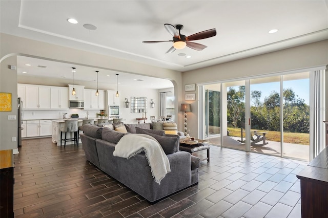 living room featuring dark hardwood / wood-style floors and ceiling fan