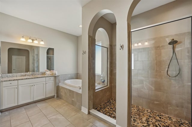 bathroom featuring tile patterned flooring, vanity, and independent shower and bath