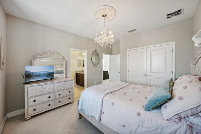 bedroom featuring a chandelier, ensuite bathroom, light carpet, and a closet