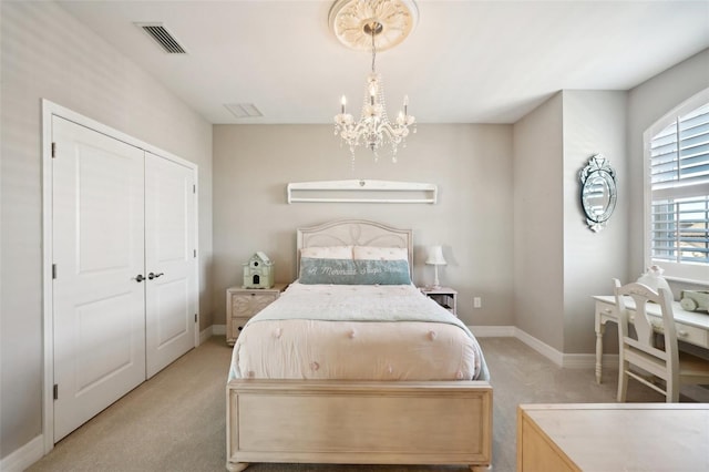 carpeted bedroom featuring a closet and a chandelier