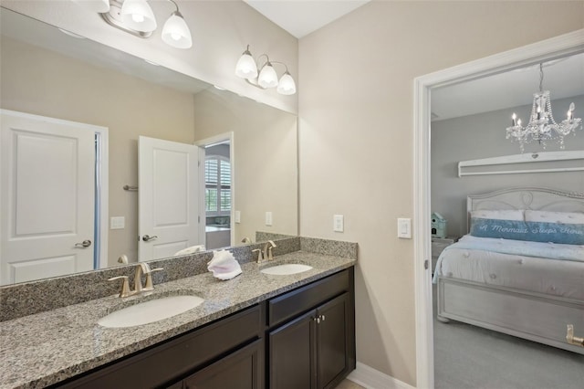 bathroom with vanity and an inviting chandelier