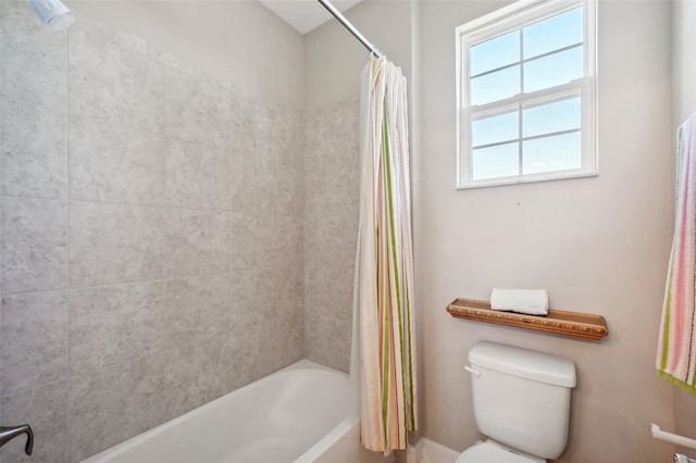 bathroom with shower / tub combo and toilet