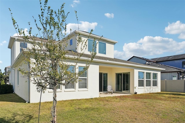 back of house with a patio area and a yard