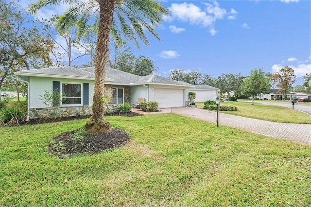 single story home featuring a front yard and a garage