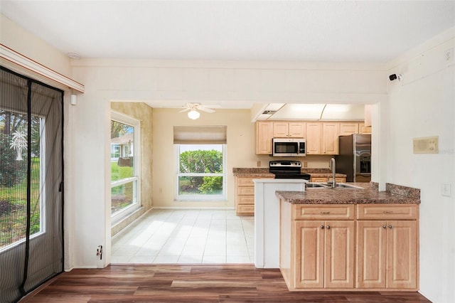 kitchen featuring sink, hardwood / wood-style flooring, ceiling fan, light brown cabinetry, and stainless steel appliances