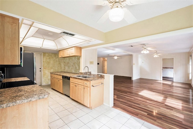 kitchen with dishwasher, stove, sink, light brown cabinetry, and light tile patterned flooring