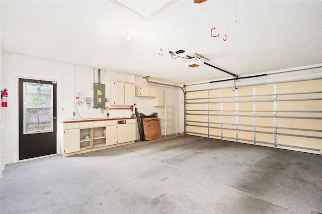 garage featuring electric panel and a garage door opener