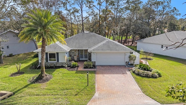 ranch-style house with a garage and a front lawn