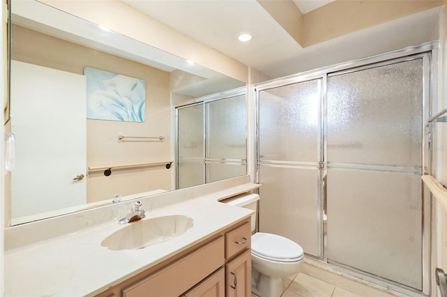 bathroom with tile patterned flooring, vanity, toilet, and walk in shower