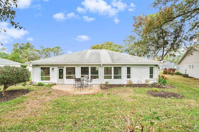 rear view of house with a lawn and a patio area