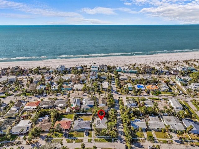 birds eye view of property with a water view and a beach view