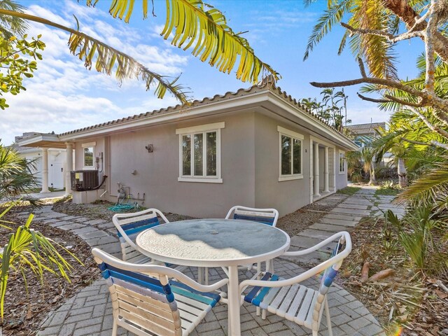 35 Juniper Way, Clearwater Beach, FL 33767 - view of patio / terrace featuring outdoor dining area and central AC unit