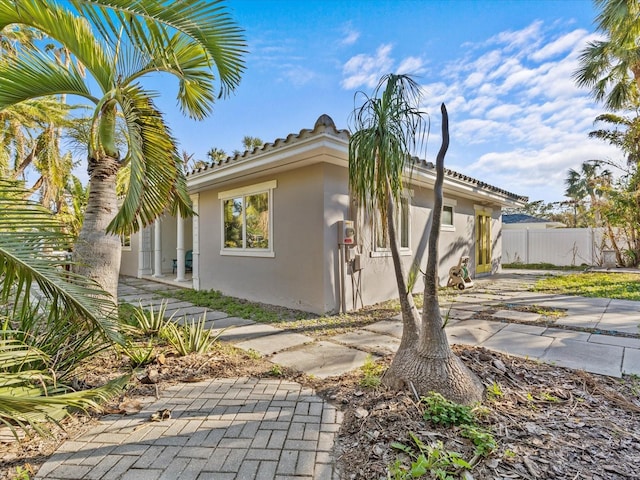 35 Juniper Way, Clearwater Beach, FL 33767 - view of property exterior featuring stucco siding and a patio area