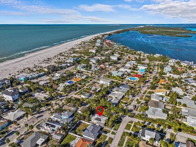 bird's eye view with a water view and a beach view