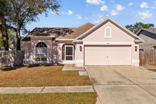 ranch-style home with a garage and a front lawn