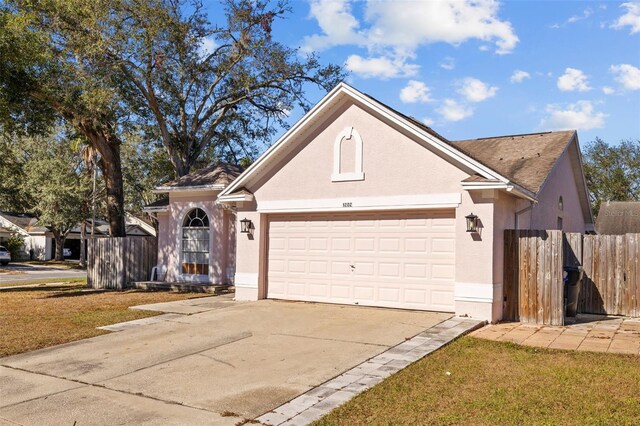1202 Sawdust Ct, Valrico, FL 33596 - traditional-style home with a garage, stucco siding, and driveway