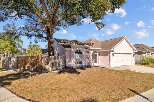 view of front facade featuring a front yard and a garage